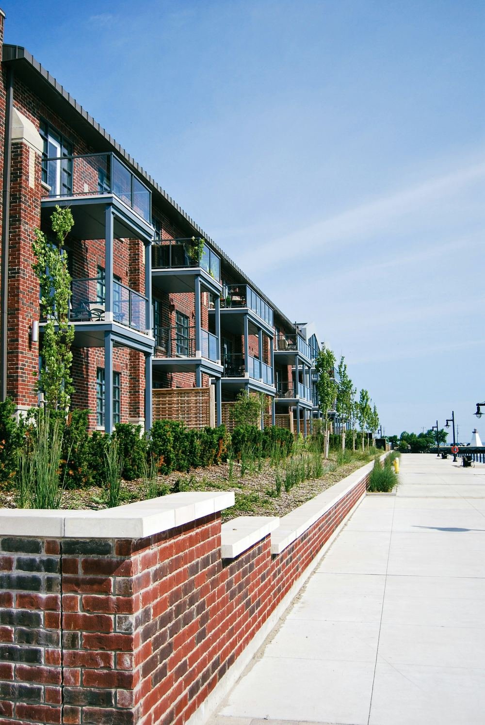 Brick apartment community with planted balconies